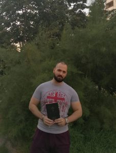 Pedja holding his Pedja reading the New Serbian Translation Bible