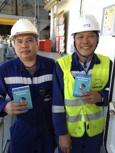 2 Philippino sailors with the bi-Lingual (English/Tagalog) NIV New Testaments