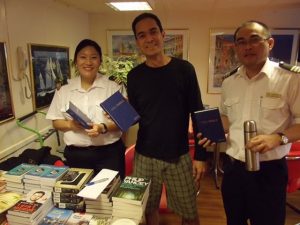 Woman getting her extra Bibles for the on board Fellowship group